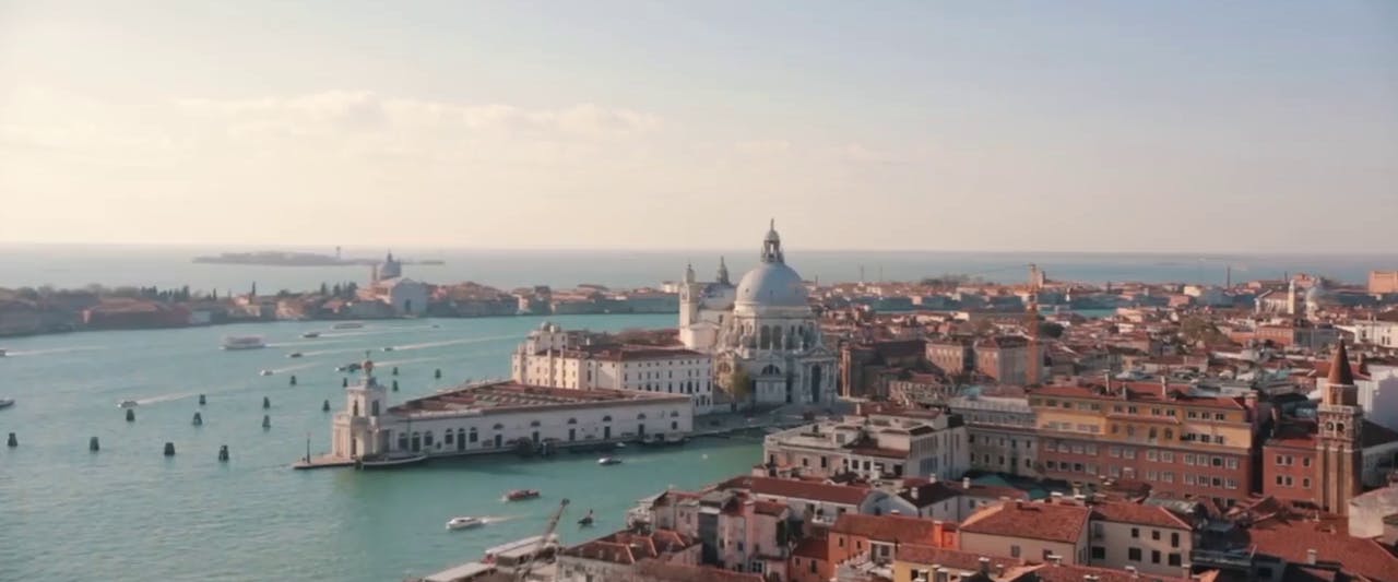 Gondola gliding through Venice's Grand Canal with historic buildings in view.