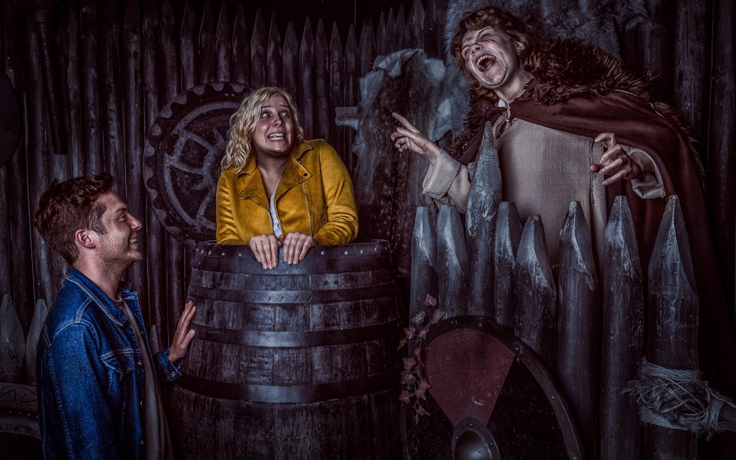 Visitors interact with actors in Viking-themed setting at York Dungeon.