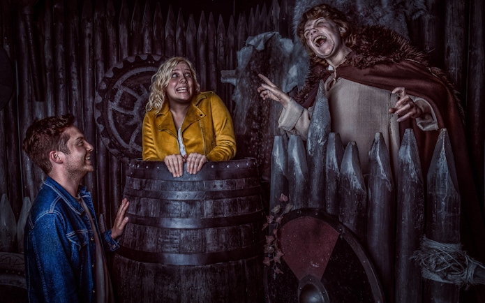 Visitors interact with actors in Viking-themed setting at York Dungeon.