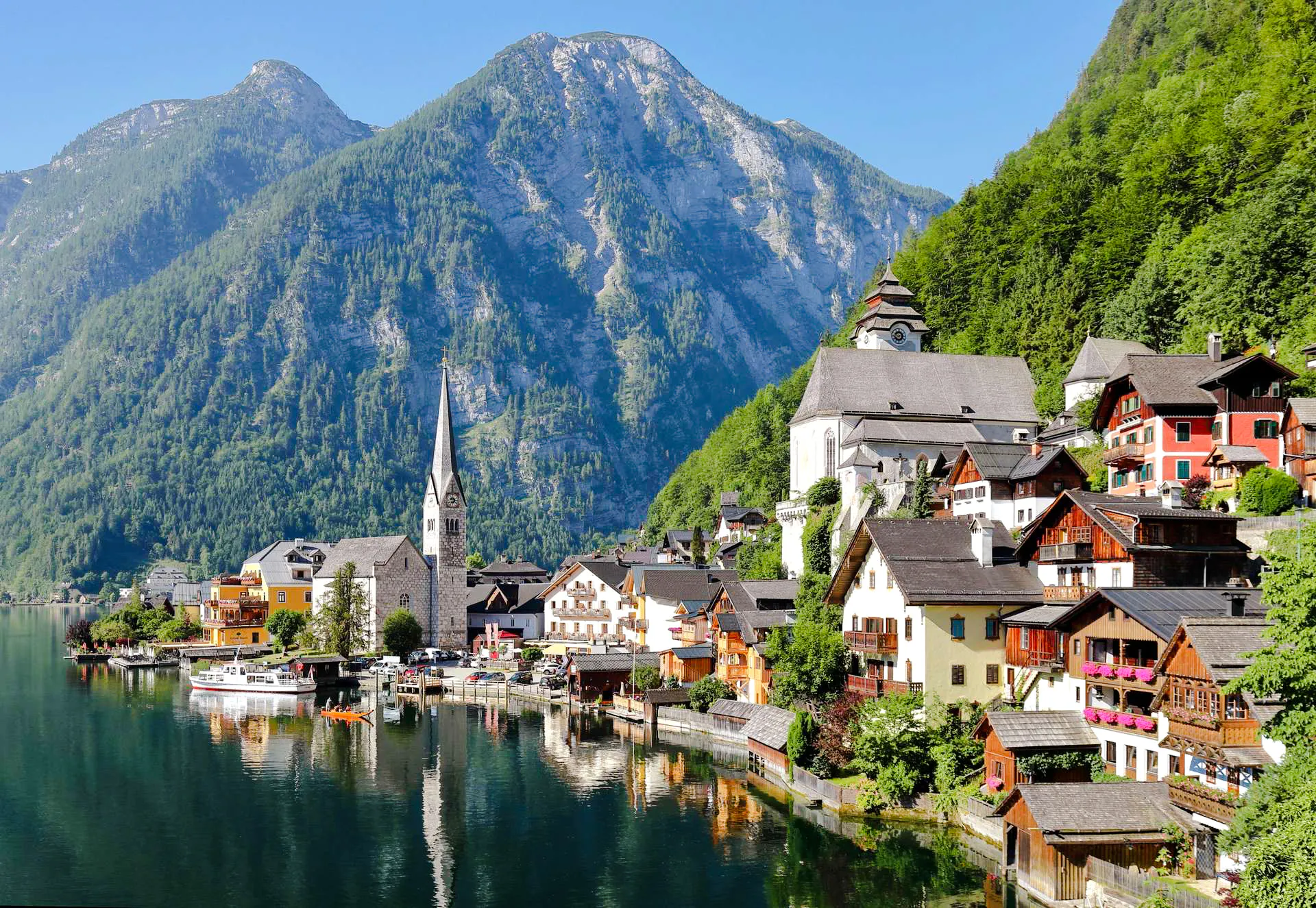 Hallstatt village with church and alpine lake, part of Salzburg guided tour.