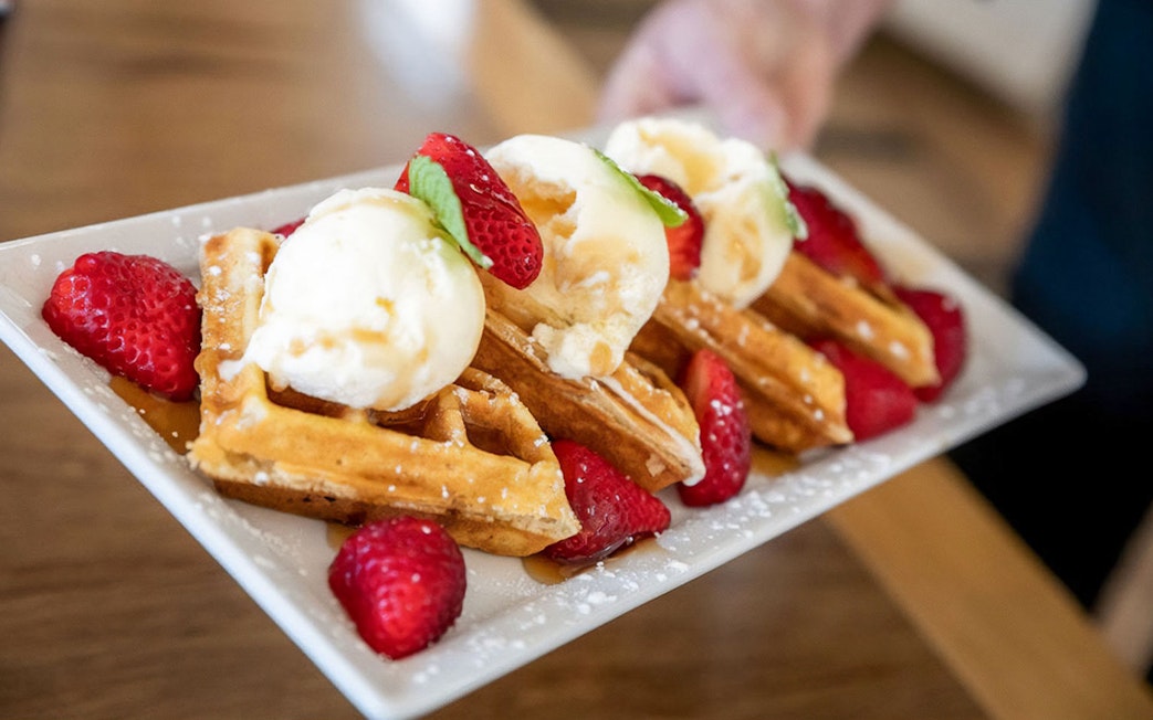 Waffles with ice cream and strawberries served on the Mary Valley Rattler Train Experience.