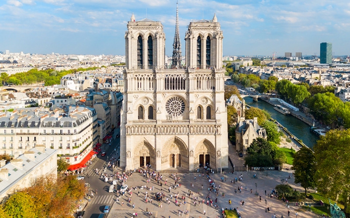 Notre Dame Cathedral in Paris with surrounding cityscape and Seine River.