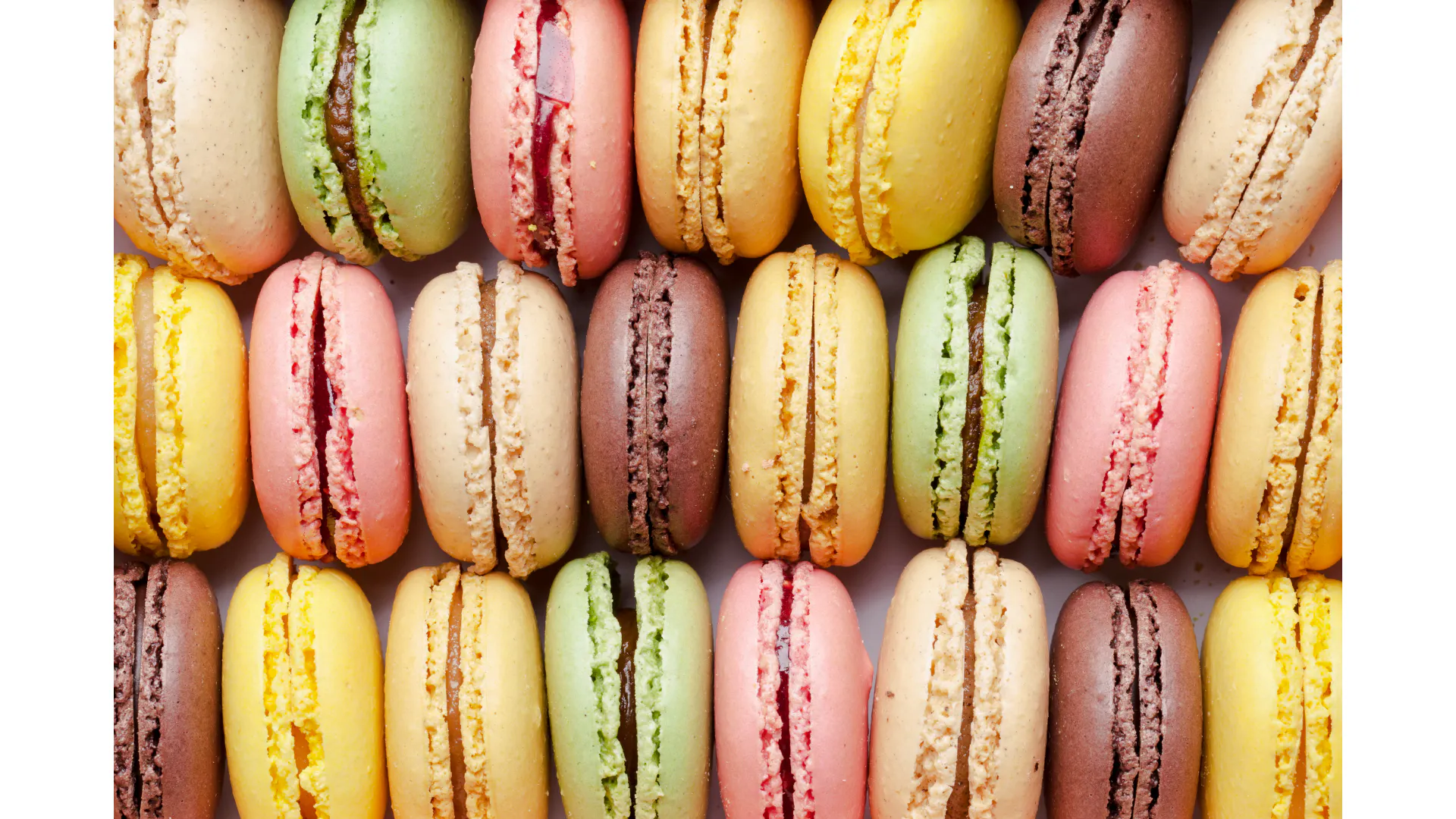 Colorful macarons arranged in rows, part of the Champs-Élysées Tasting Walk in Paris.