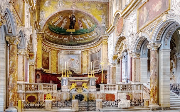 Interior of Basilica of San Marco in Rome featuring ornate altar and detailed frescoes.