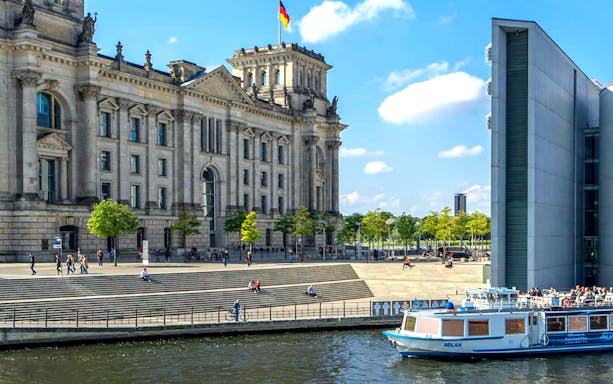 Cruise boat on the Spree River near the Reichstag building in Berlin.
