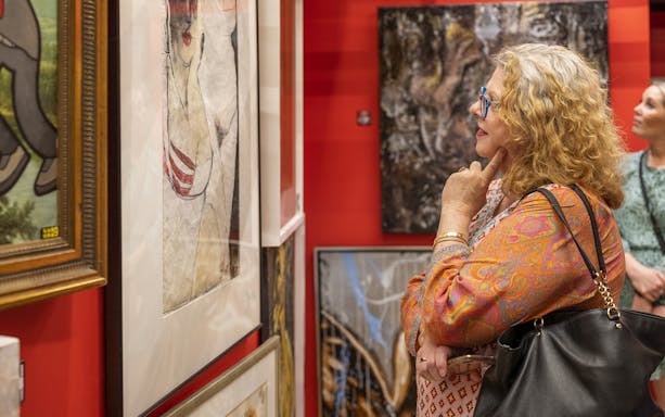 Visitor admiring artwork at McLaren Vale's Cube Experience gallery.