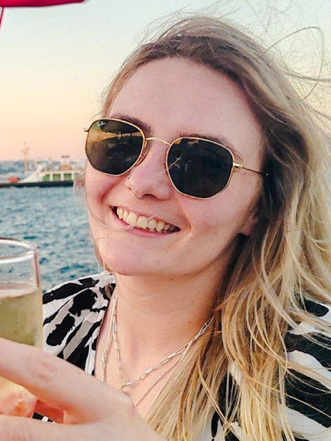 Toasting with drinks on a Bosphorus private luxury yacht, Istanbul skyline in background.