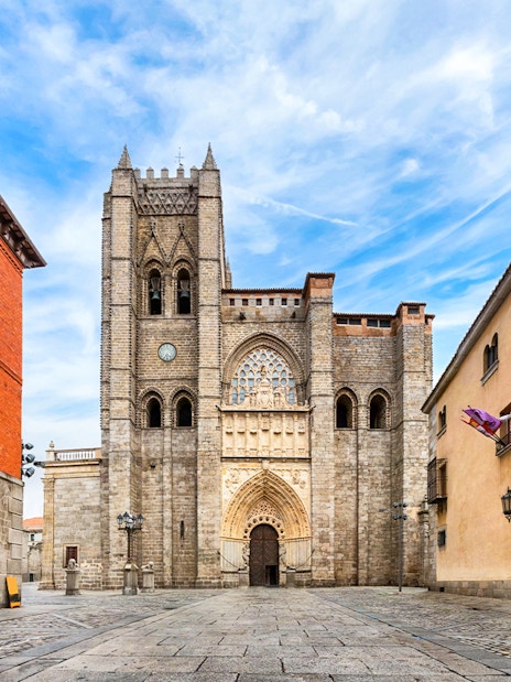 Ávila Cathedral facade with surrounding historic buildings in Spain.