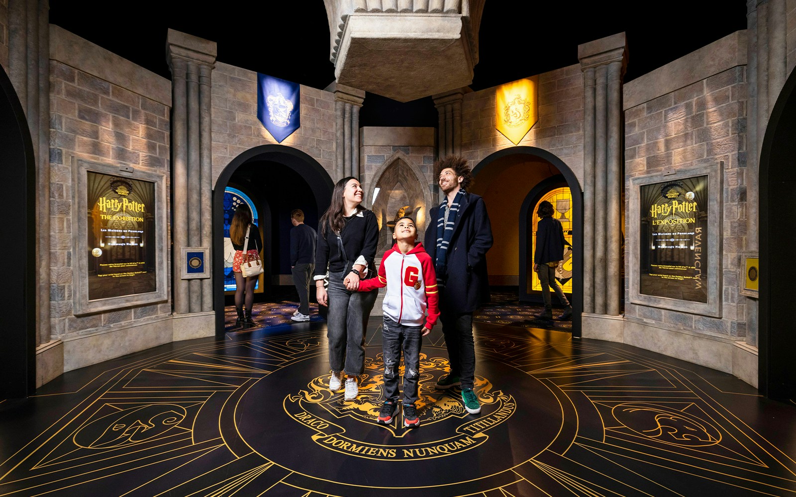 Visitors exploring Hogwarts-themed room at Harry Potter™: The Exhibition.