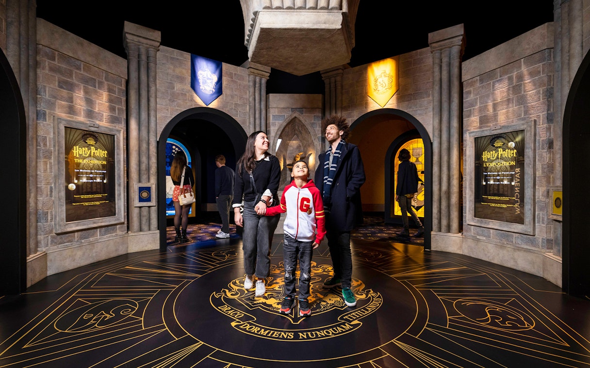Visitors exploring Hogwarts-themed room at Harry Potter™: The Exhibition.