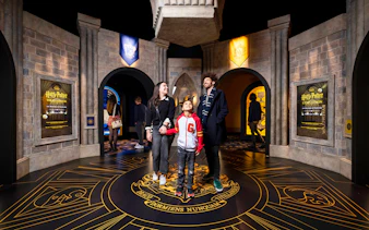 Visitors exploring Hogwarts-themed room at Harry Potter™: The Exhibition.
