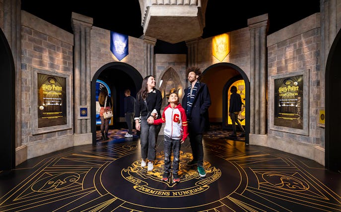 Visitors exploring Hogwarts-themed room at Harry Potter™: The Exhibition.