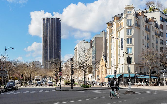 Montparnasse Tower and street view during walking tour in Paris.
