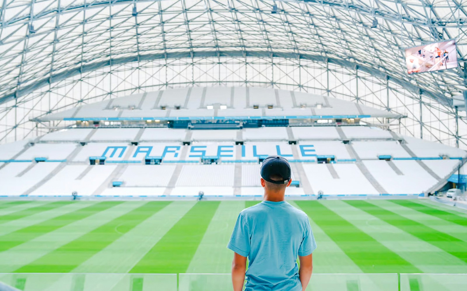 Person viewing the field inside Marseille's Velodrome Stadium.