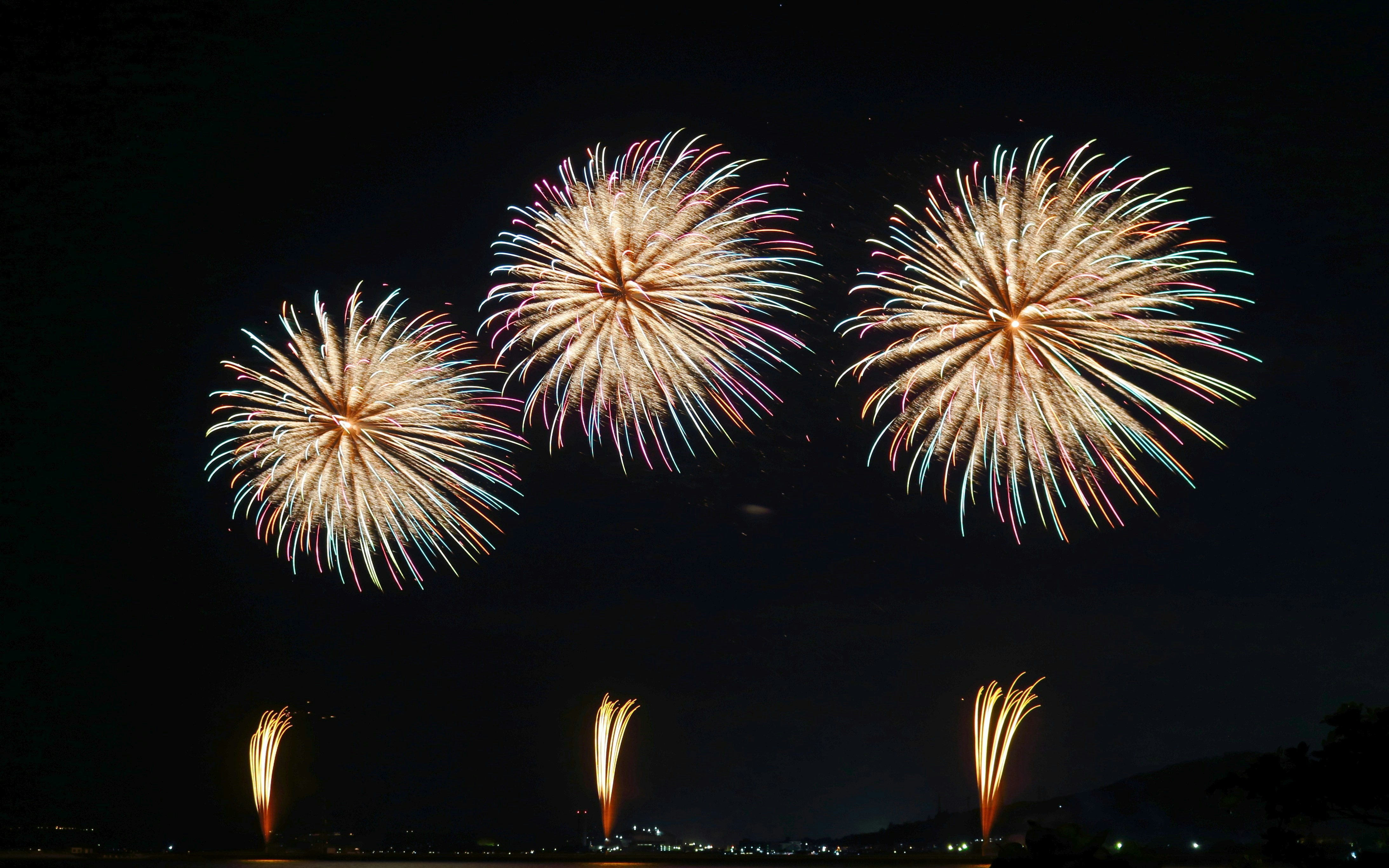 Fireworks display over Okinawa night sky.