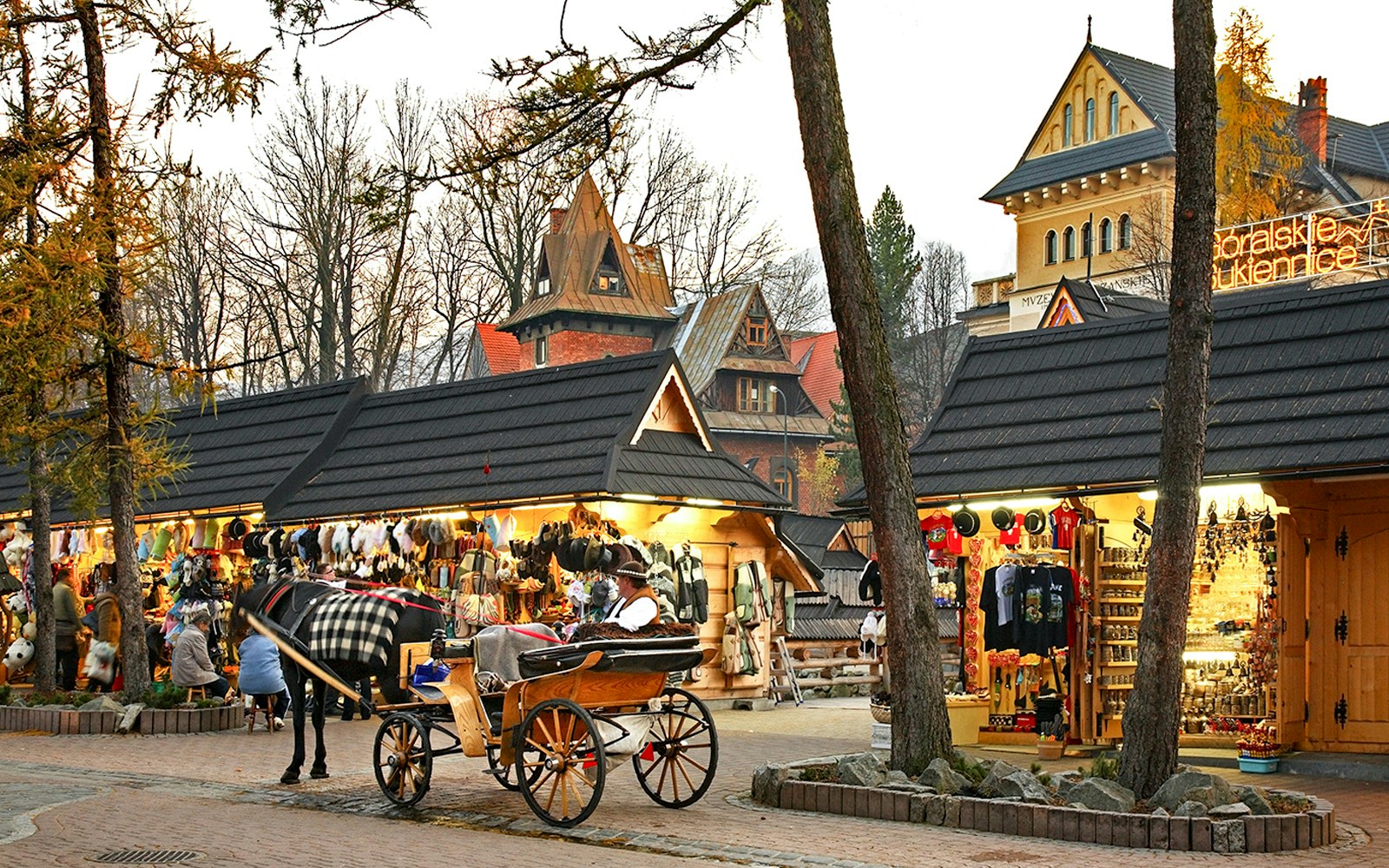 Horse-drawn carriage near market stalls in Zakopane, Poland.
