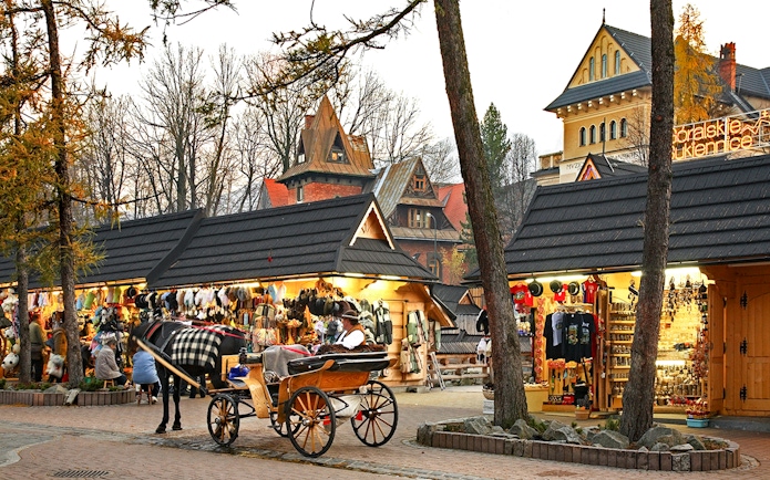 Horse-drawn carriage near market stalls in Zakopane, Poland.