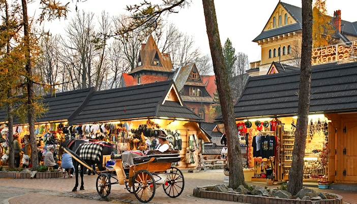 Horse-drawn carriage near market stalls in Zakopane, Poland.