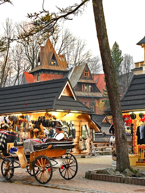 Horse-drawn carriage near market stalls in Zakopane, Poland.