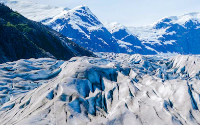 Glacier landscape with hikers during Norris Adventure tour in Alaska.
