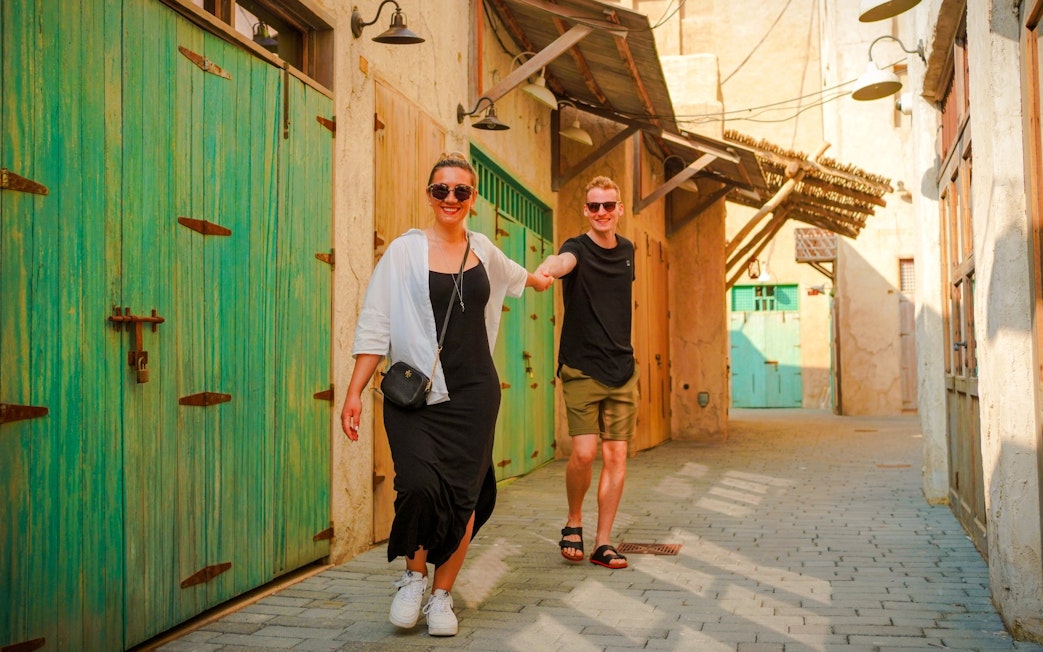 Couple walking through Al Khayma's traditional alleyway.