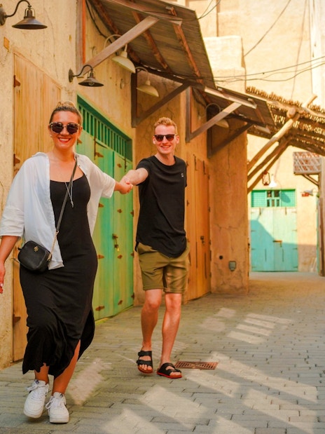 Couple walking through Al Khayma's traditional alleyway.