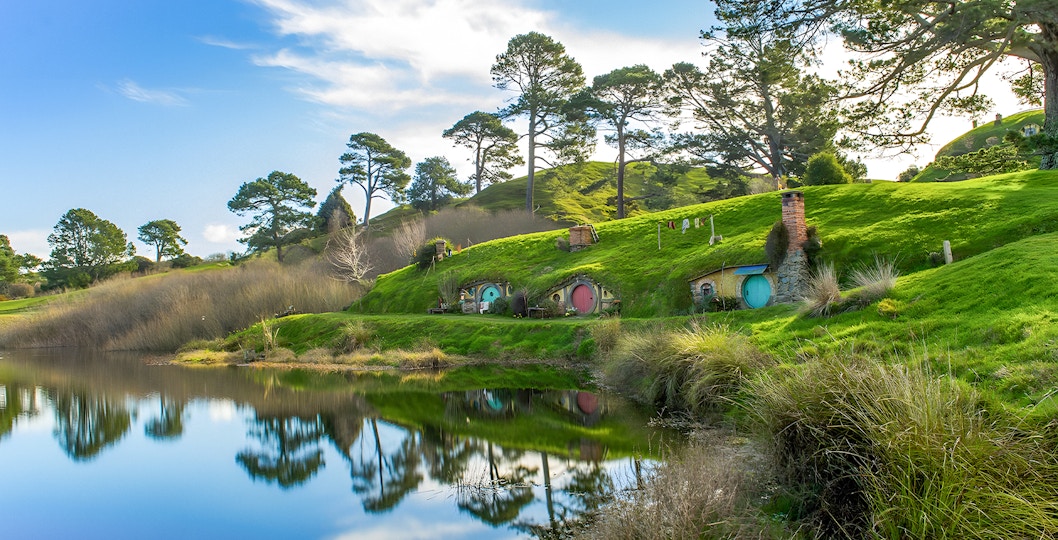Hobbiton Movie Set and Waitomo Caves tour from Auckland with lush landscapes.
