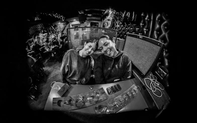 Two people smiling at a bar in Reykjavík during a private bar crawl with drinks.