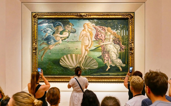 Tourists viewing Botticelli's "The Birth of Venus" at Uffizi Gallery, Florence.
