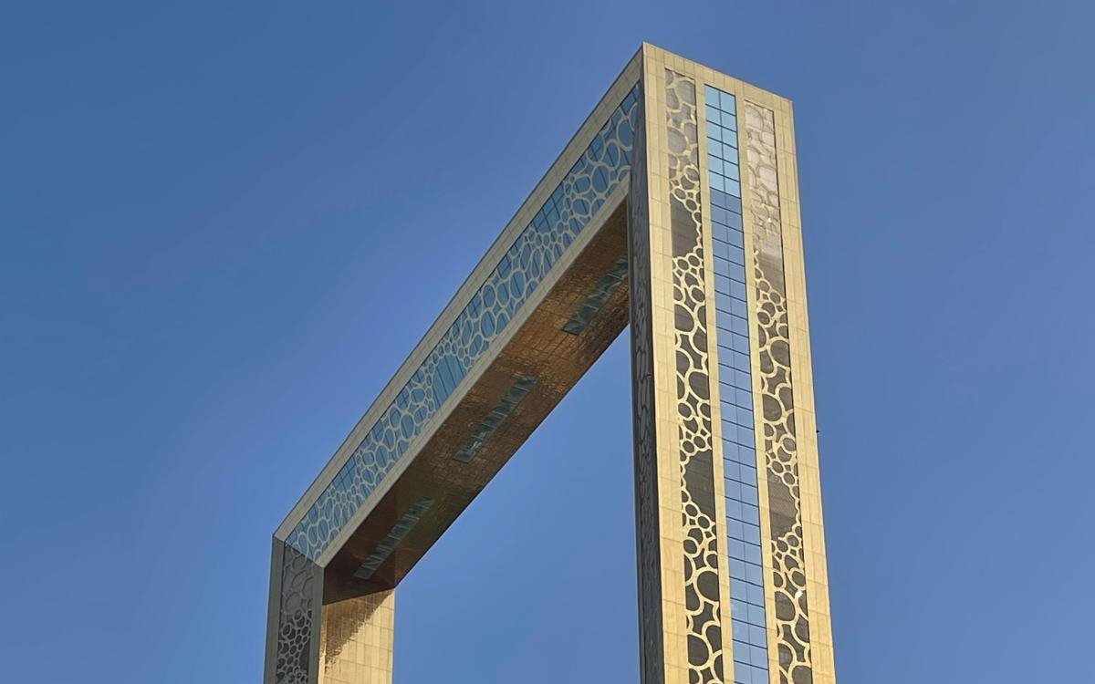 Elevator side of Dubai Frame against clear blue sky.