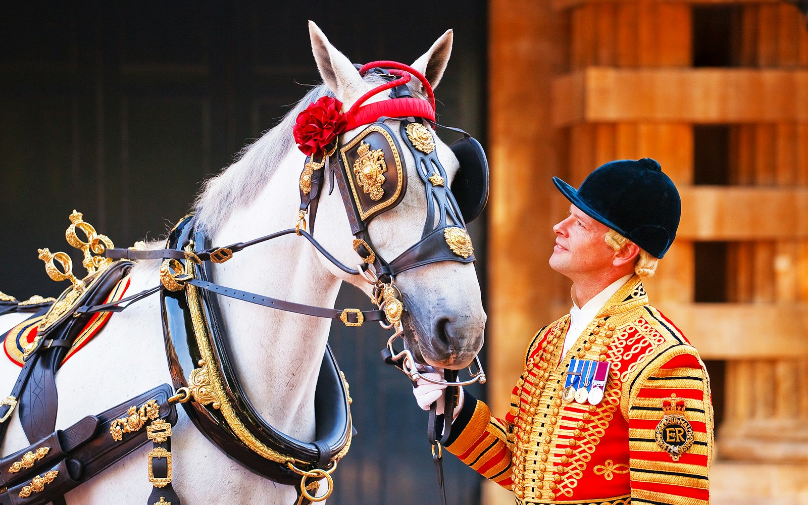 Royal guard in ceremonial uniform with decorated horse in London.
