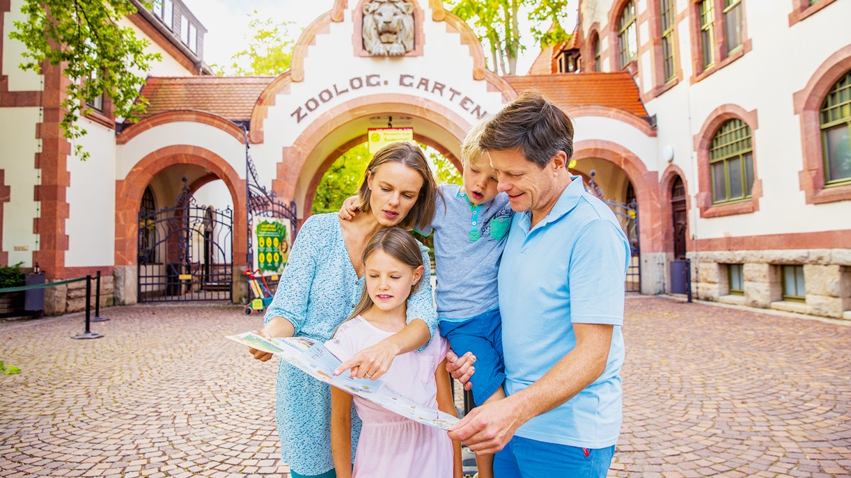 Family enjoying their visit with Tickets to Zoo Leipzig, Germany, viewing exotic animals in a naturalistic habitat