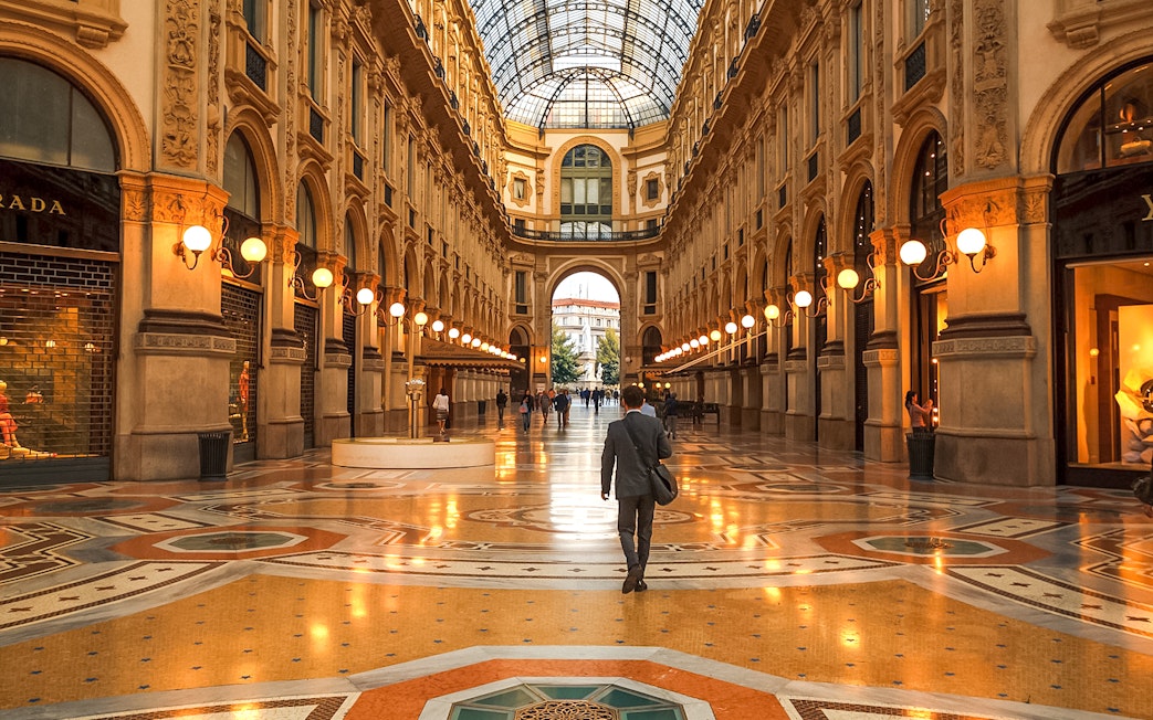 Galleria Vittorio Emanuele II interior with people walking, Milan, Italy.