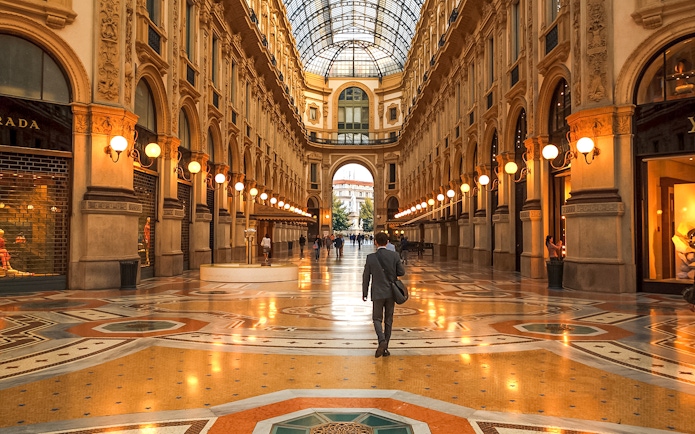 Galleria Vittorio Emanuele II interior with people walking, Milan, Italy.