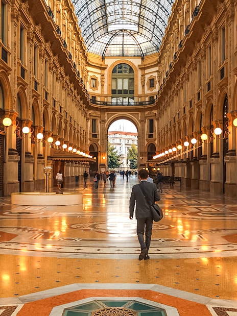 Galleria Vittorio Emanuele II interior with people walking, Milan, Italy.