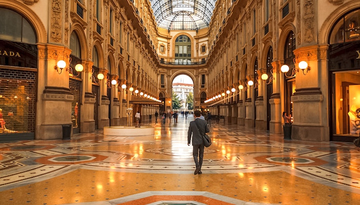 Galleria Vittorio Emanuele II interior with people walking, Milan, Italy.