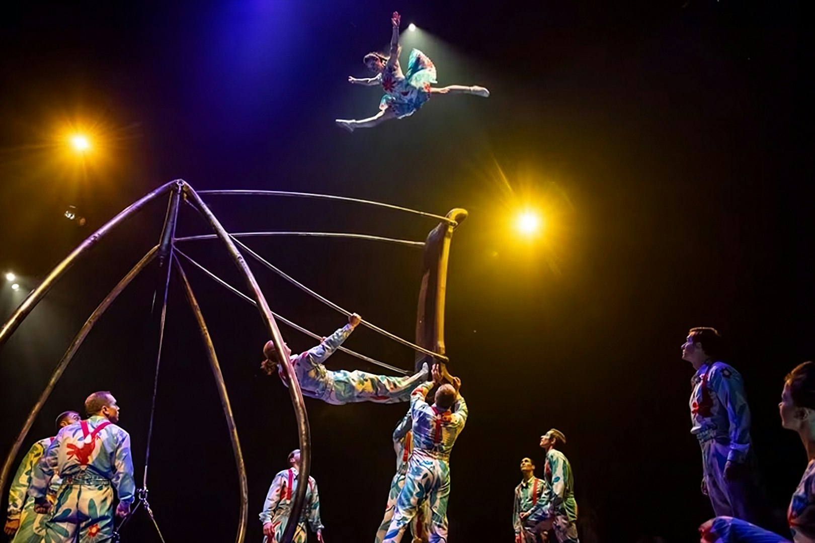 Acrobats performing high-flying stunts in Luzia show.