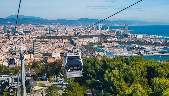 Montjuic Cable Car overlooking Barcelona cityscape and harbor.