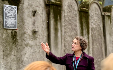 Tour guide explaining historical site in Jewish Ghetto, Krakow, Poland.