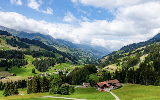 Aerial view of Swiss Alps landscape with scattered chalets, seen during a Matterhorn helicopter tour.