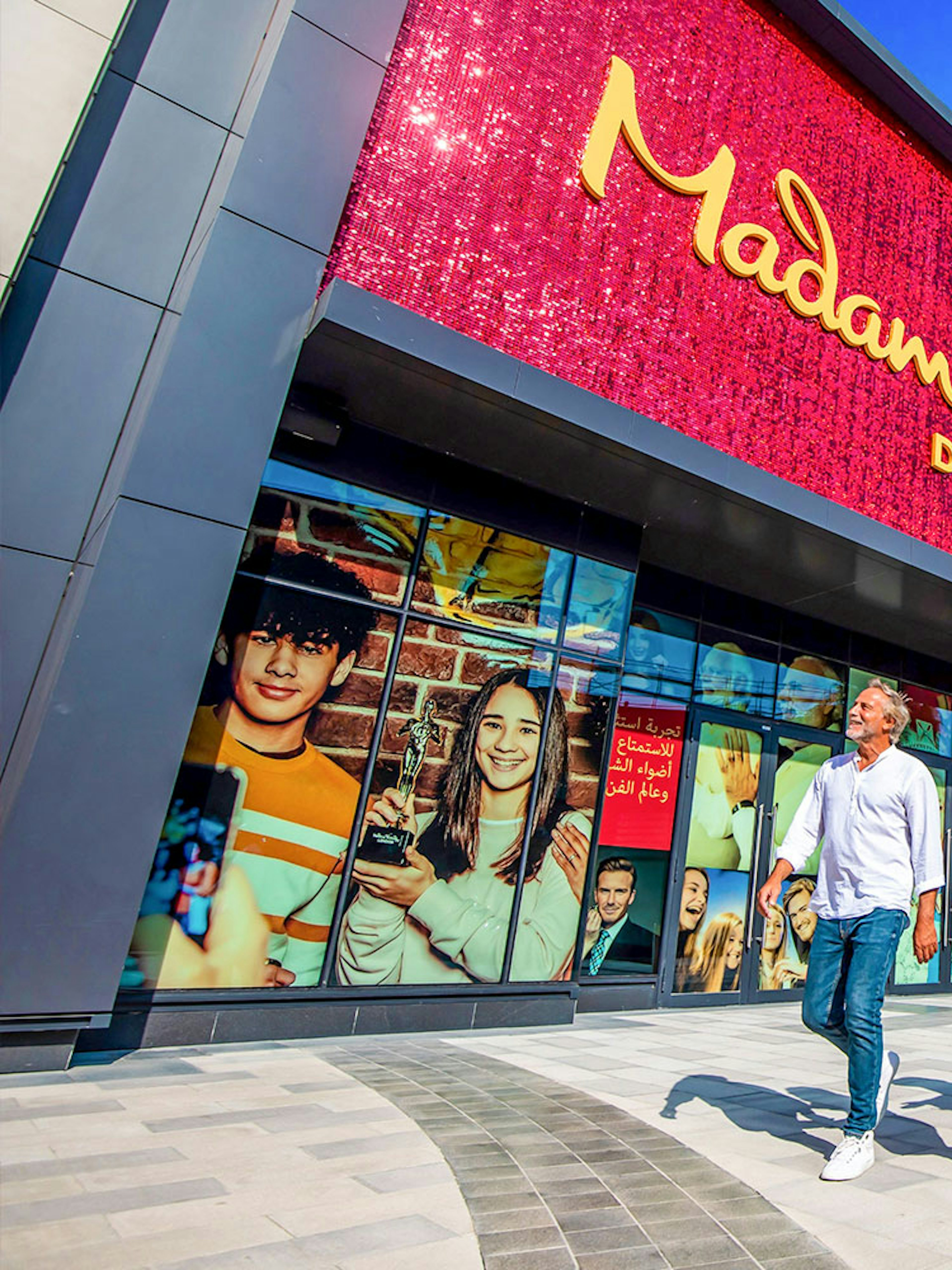 Visitors walking outside Madame Tussauds Dubai with Ain Dubai in the background.