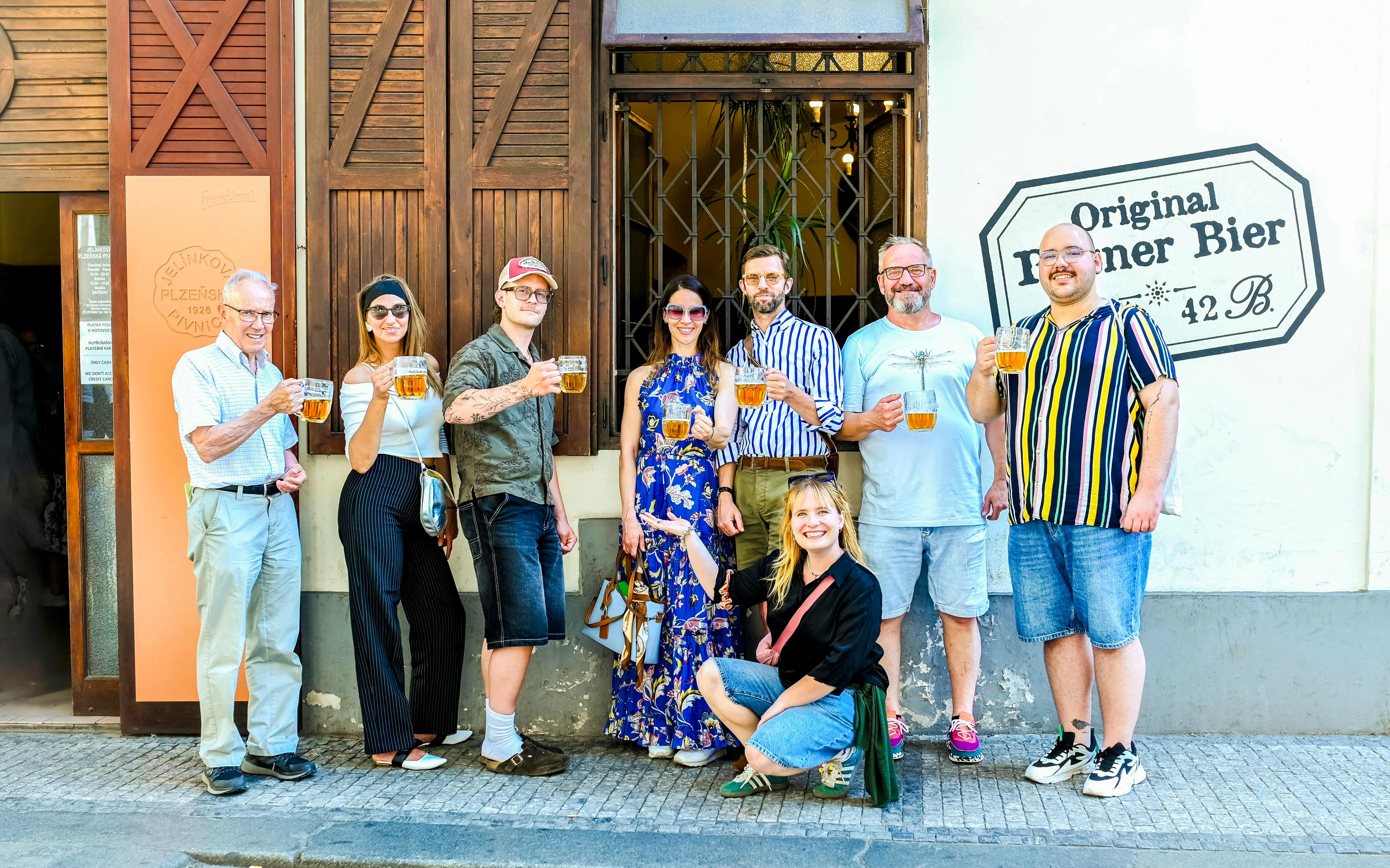Group enjoying Czech beer on Prague food tour outside a local pub.