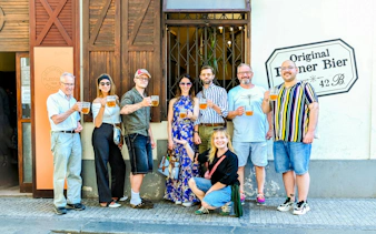 Group enjoying Czech beer on Prague food tour outside a local pub.