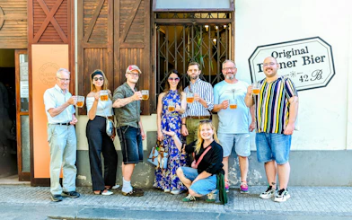 Group enjoying Czech beer on Prague food tour outside a local pub.