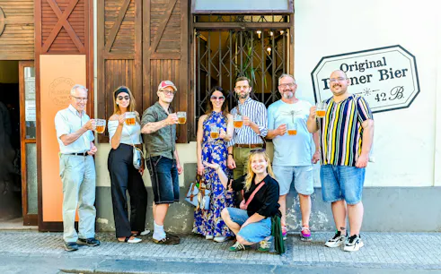 Group enjoying Czech beer on Prague food tour outside a local pub.