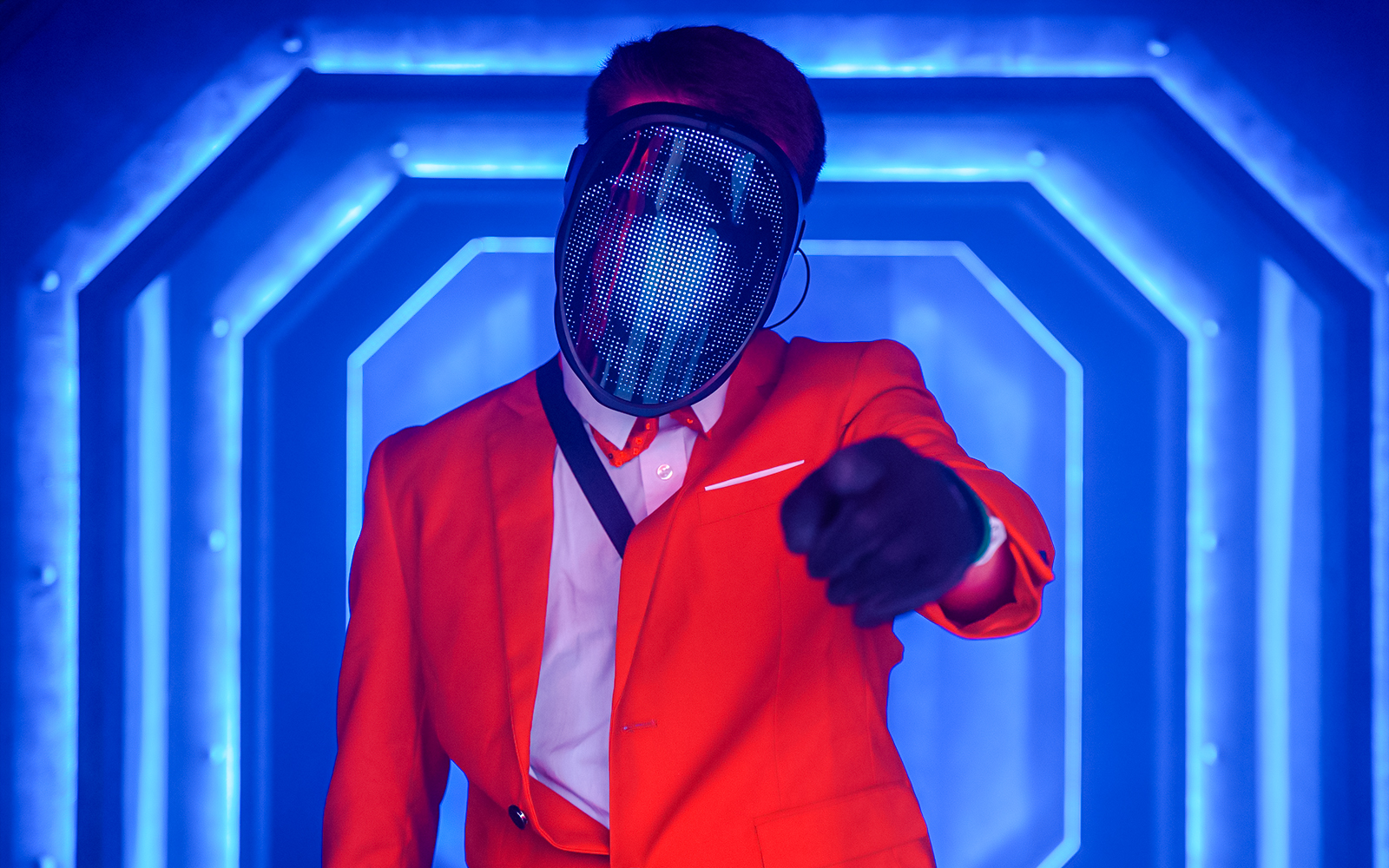 Masked performer in neon-lit corridor at Halloween event, Thorpe Park.