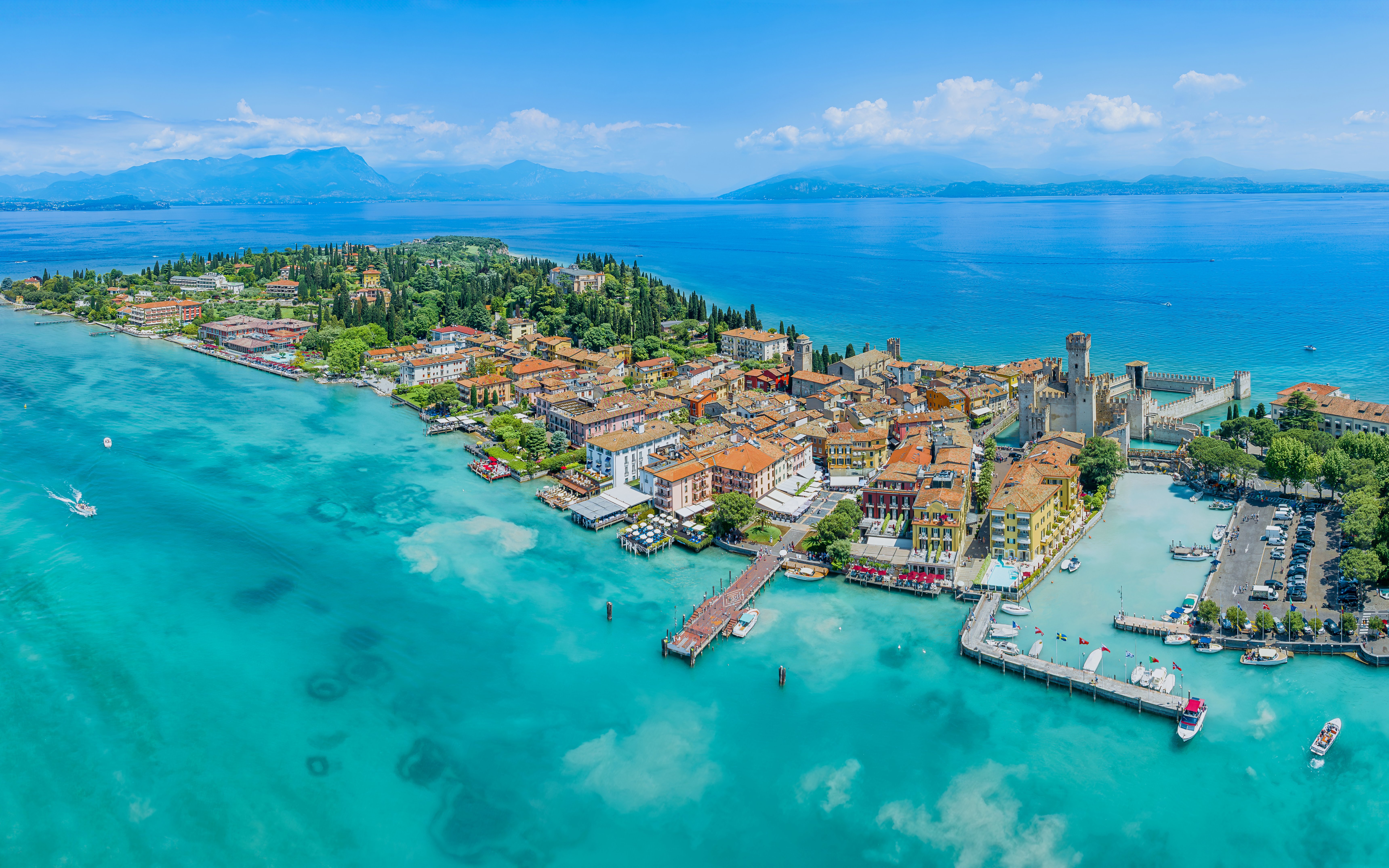 Aerial view of Sirmione town on Garda Lake, Italy, with Scaliger Castle and turquoise waters.
