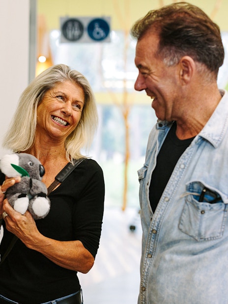 Visitors at Phillip Island gift shop with koala plush toys, Koala Conservation Reserve.