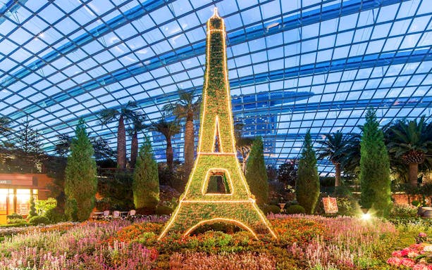 Vertical garden display resembling Eiffel Tower at Gardens by the Bay Cloud Forest, Singapore.