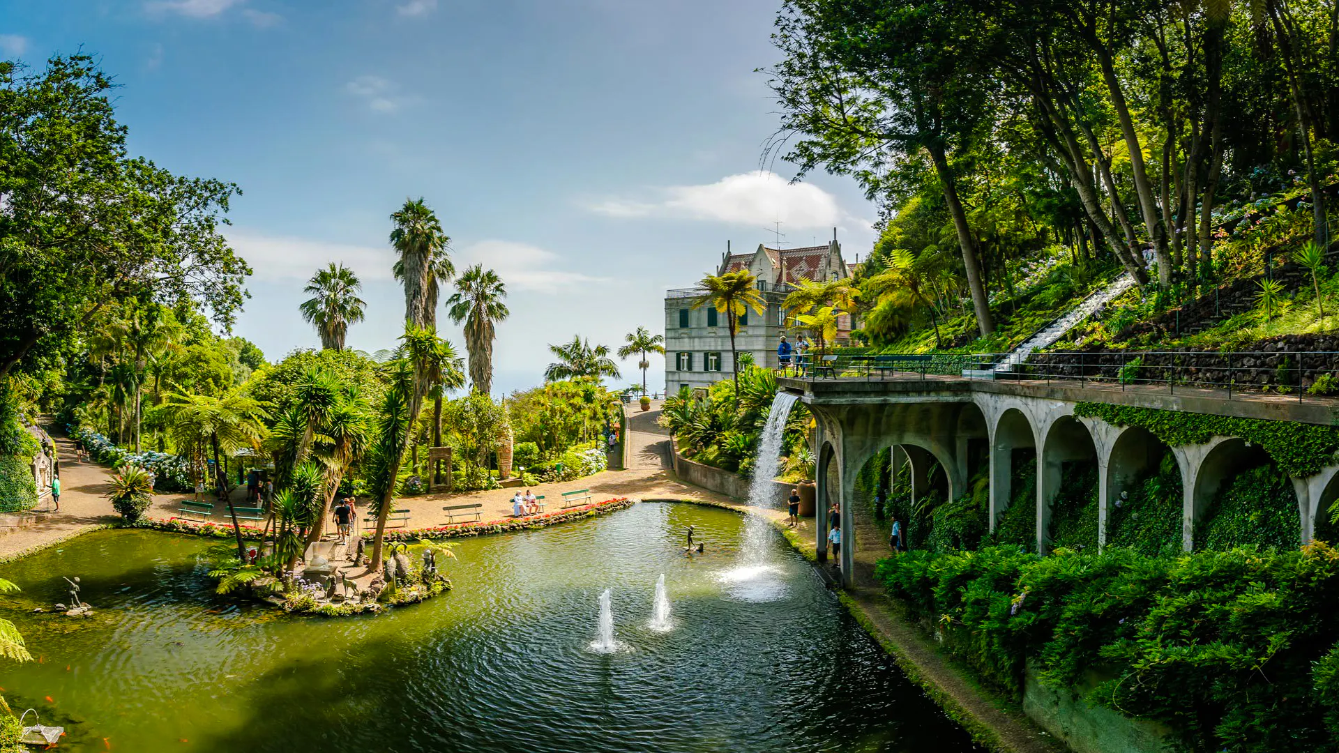 Monte Palace Madeira gardens with pond, fountains, and lush greenery, Madeira.